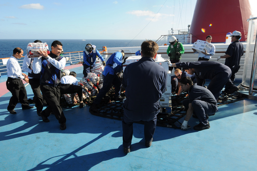 Sailors help Carnival cruise ship crew unload supplies sent